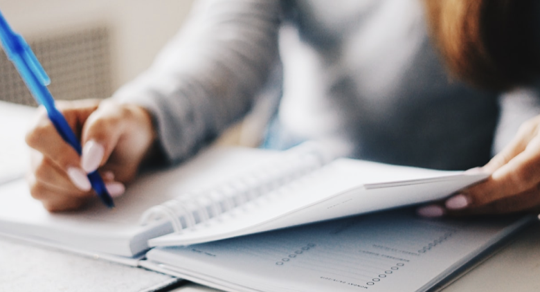 Blurred image of a person working on her notebook