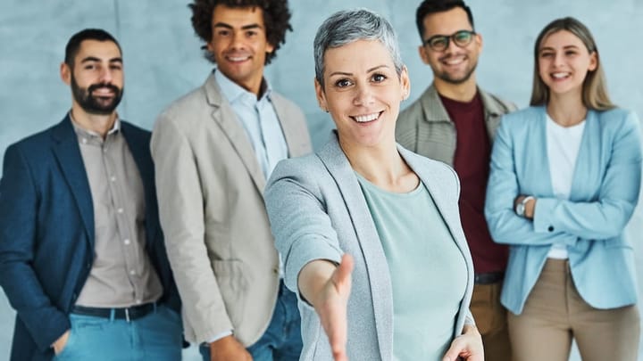 Young professionals meeting in an office with a handshake